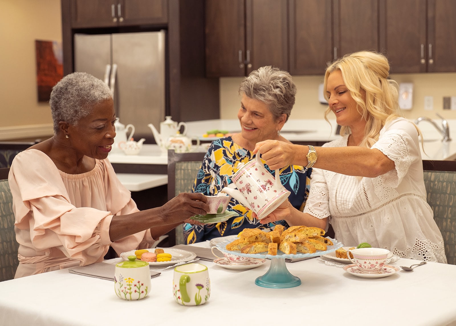 Three women enjoying tea and pastries together