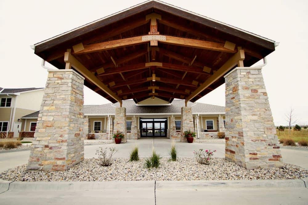 Stone pillars supporting wooden canopy at building entrance