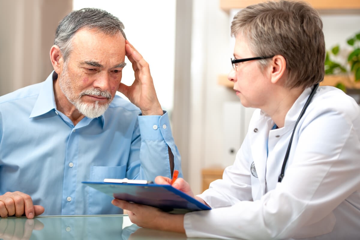 Older man discussing medical results with doctor