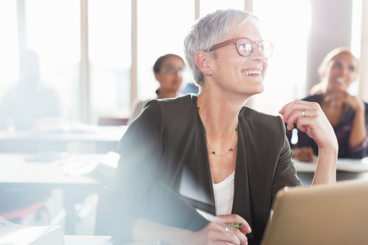 Smiling older woman with glasses in classroom