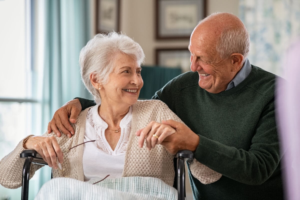 Smiling elderly couple sharing tender moment at home