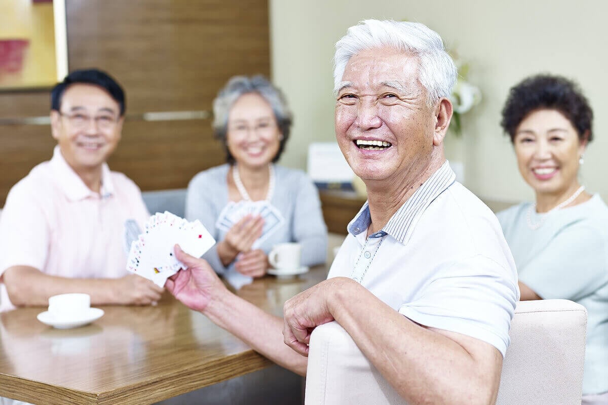 Senior friends playing cards at a table