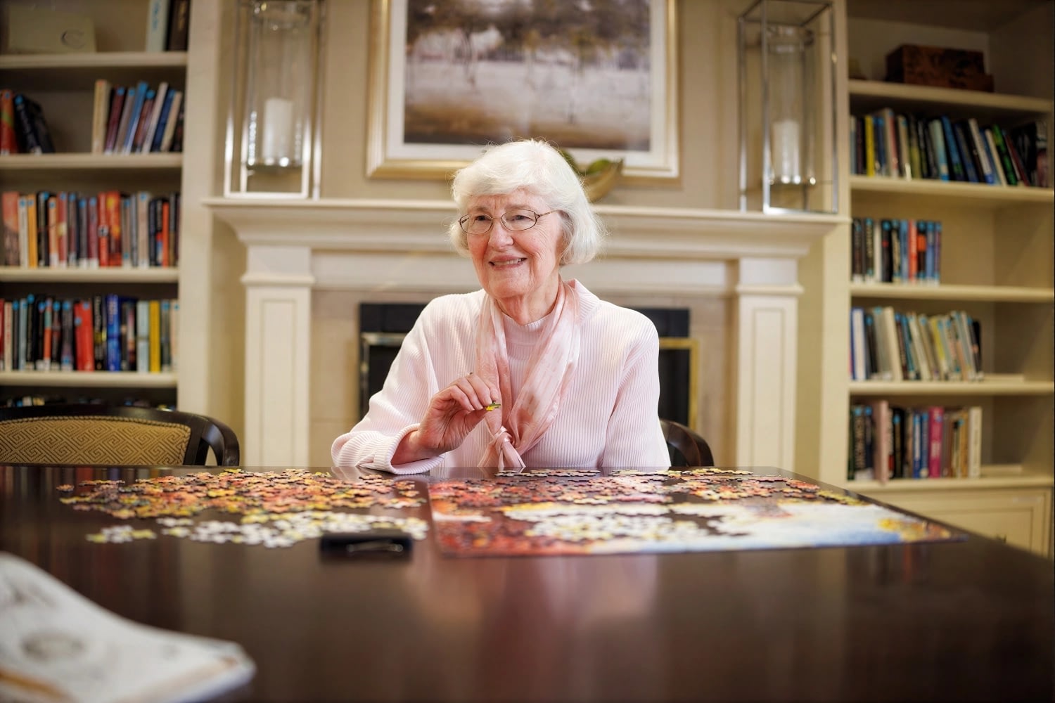 Elderly woman working on puzzle at table