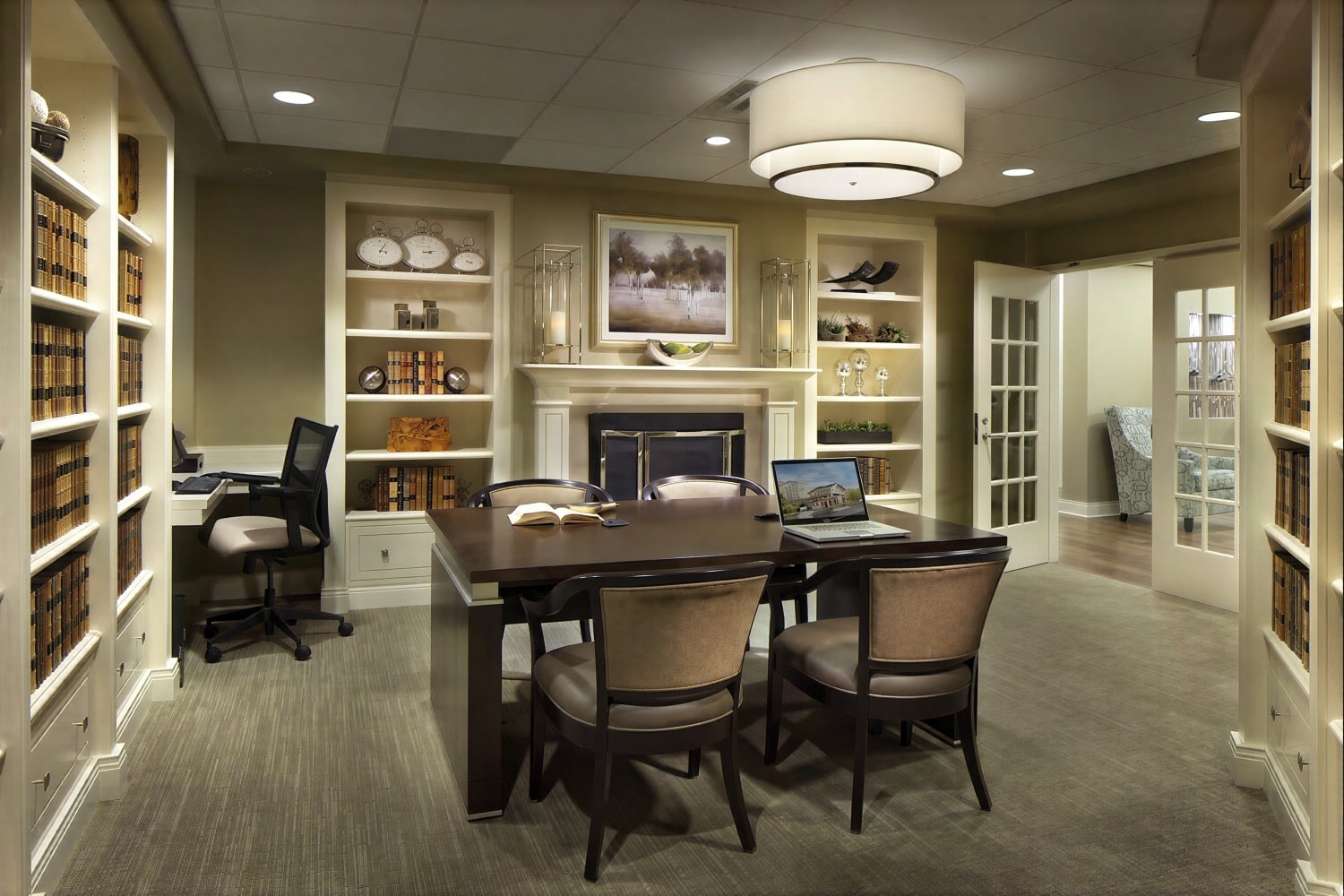 Elegant home office with bookshelves and fireplace