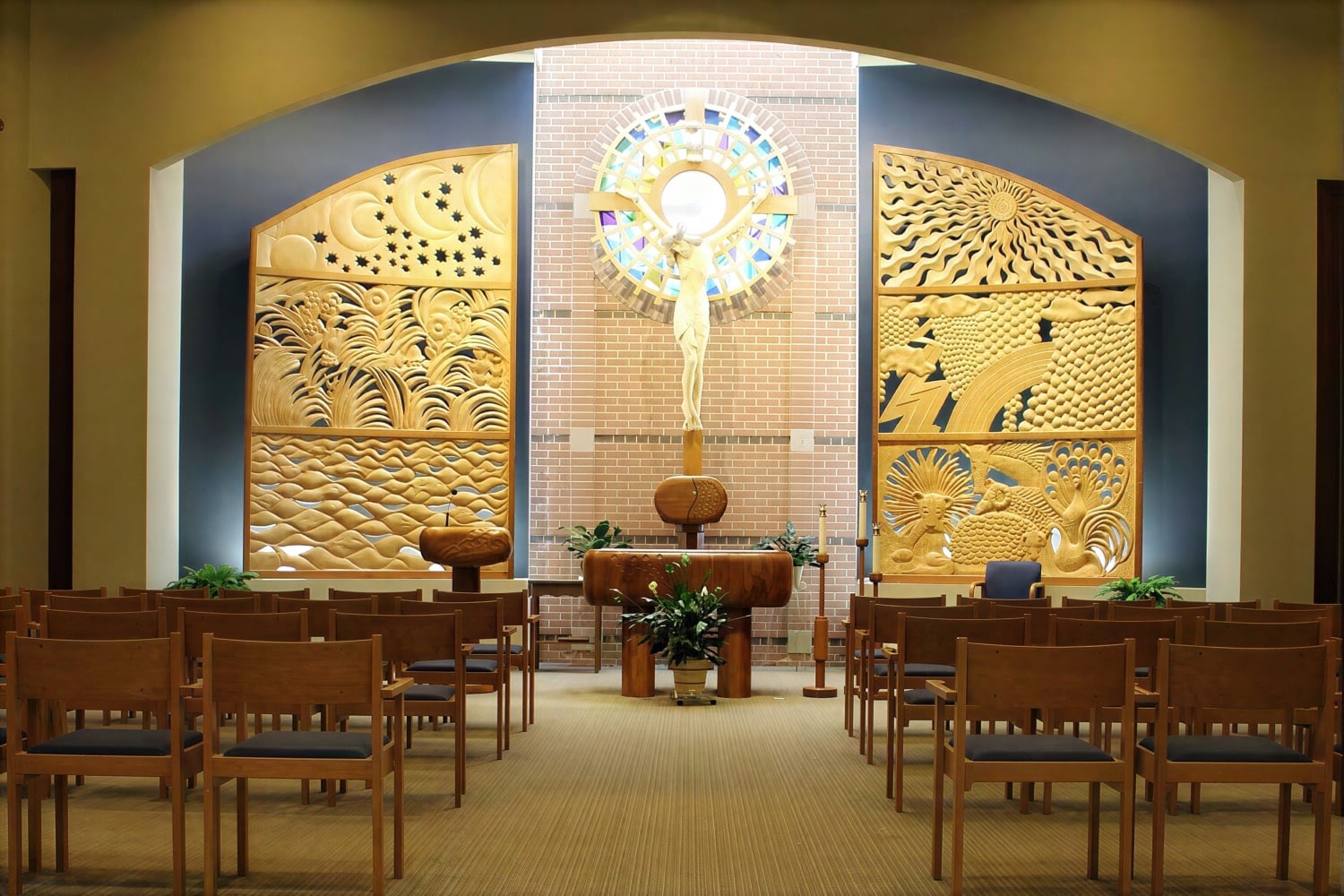 Church altar with crucifix and carved wall panels
