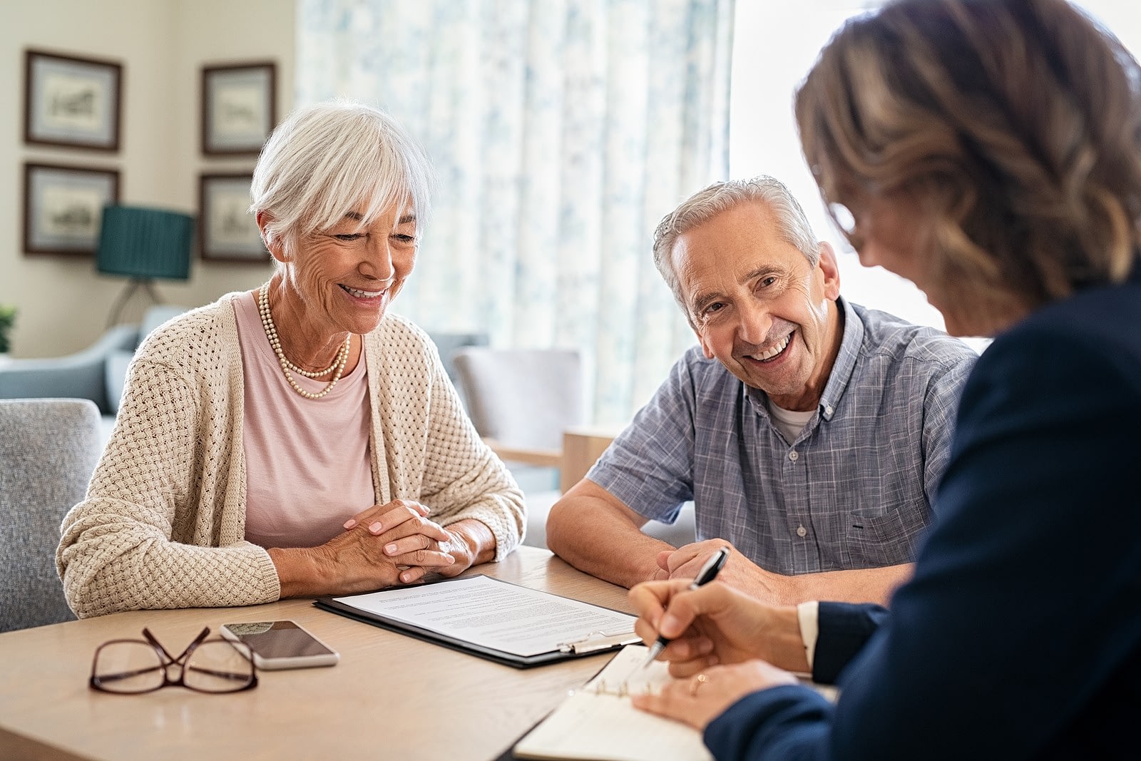 Senior couple meeting with financial advisor indoors