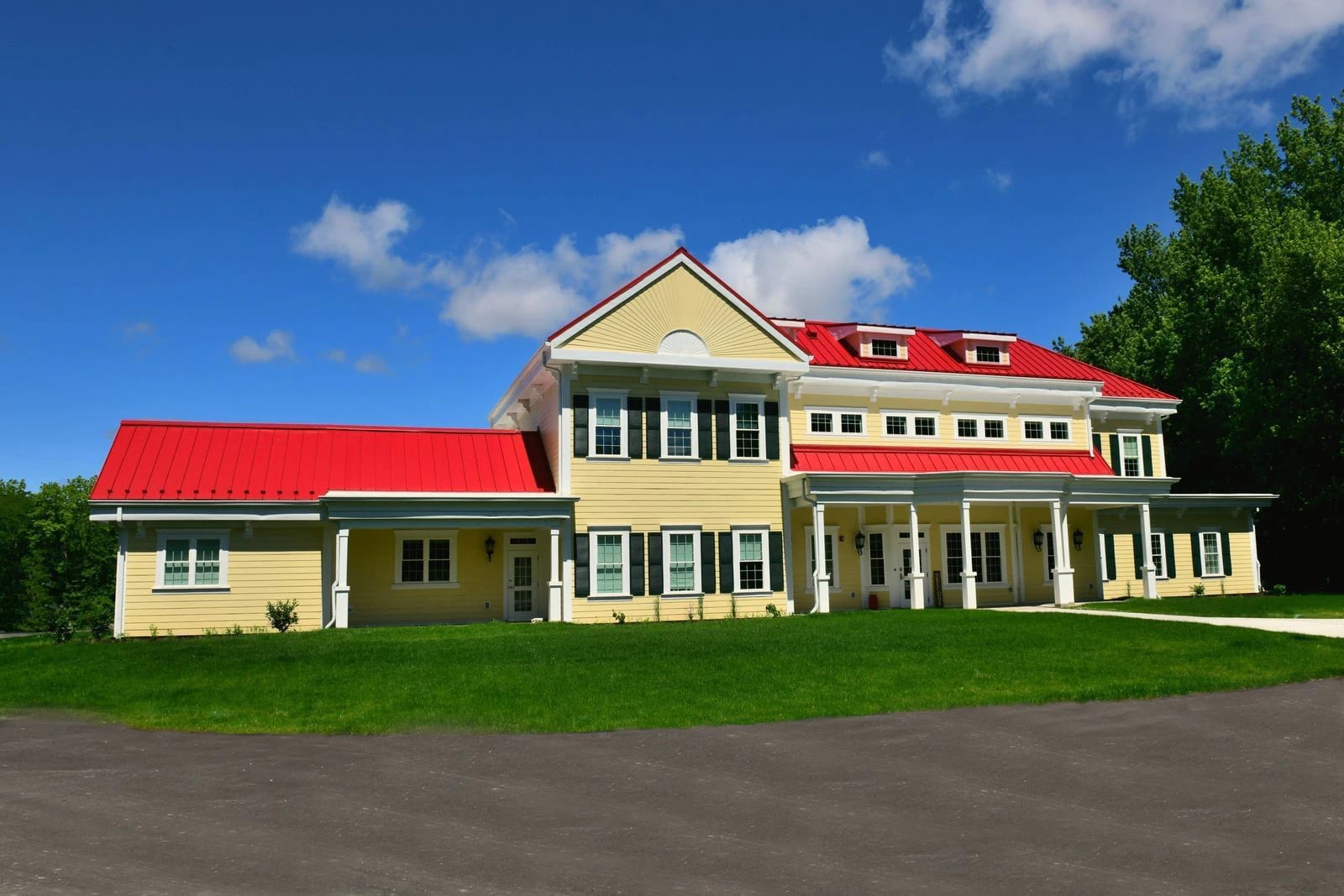 Yellow house with red roof and white columns