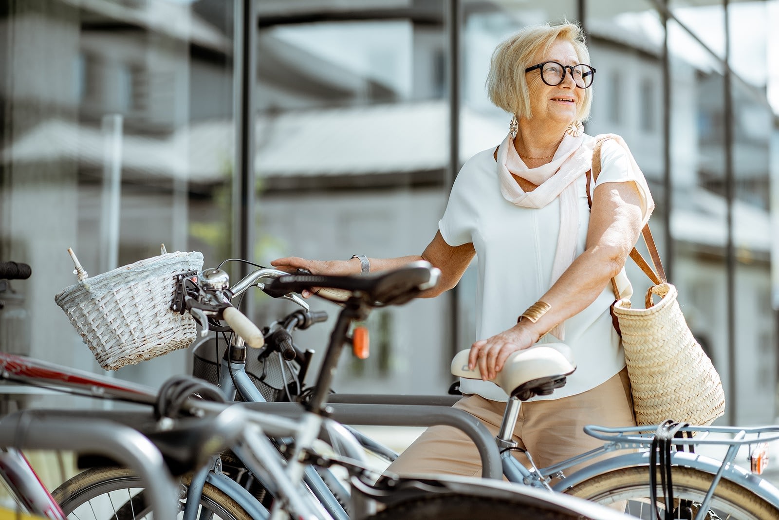 Older woman with bicycle in city setting