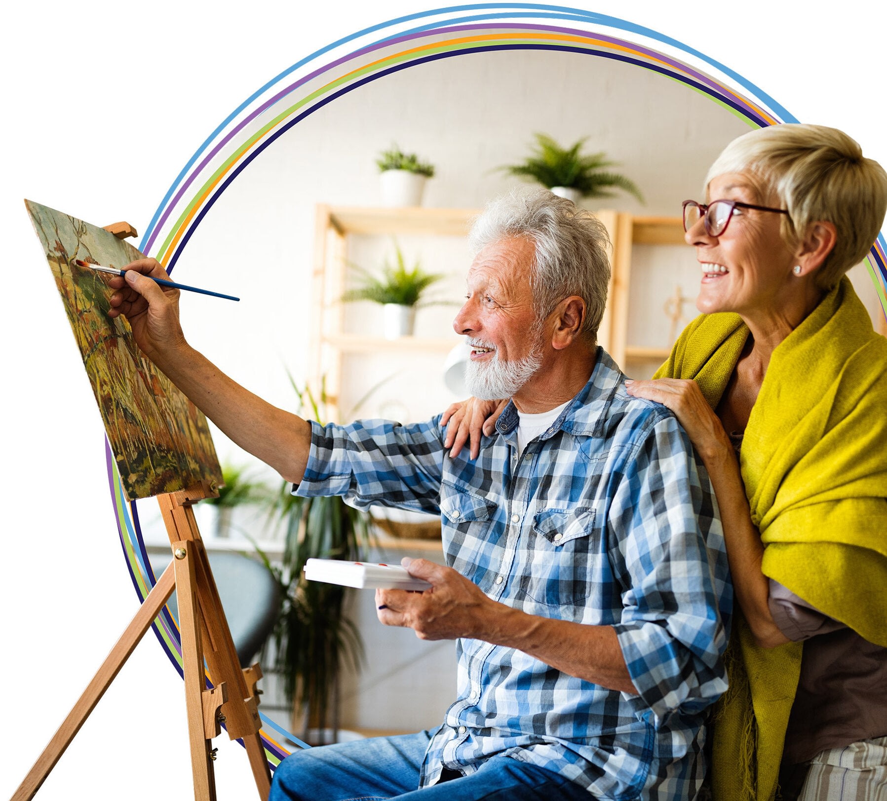Senior couple painting together at home easel