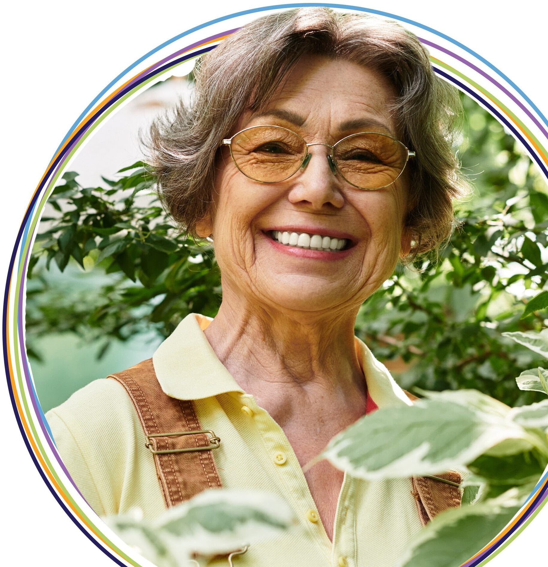 Smiling senior woman gardening in lush greenery