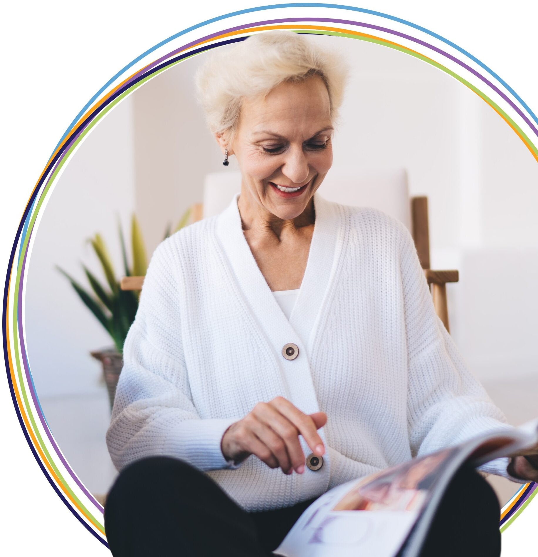Smiling older woman reading magazine indoors