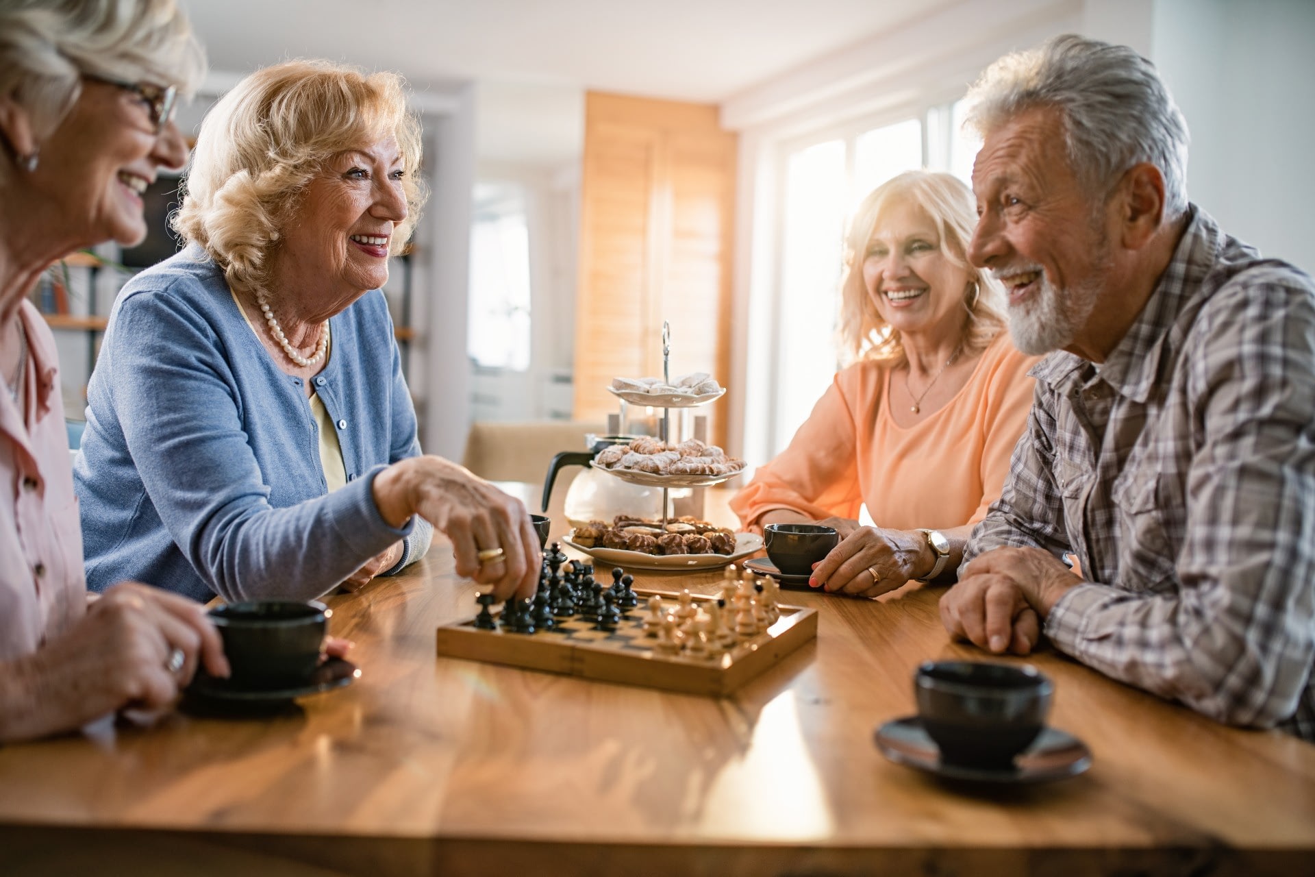Seniors playing chess and drinking coffee together