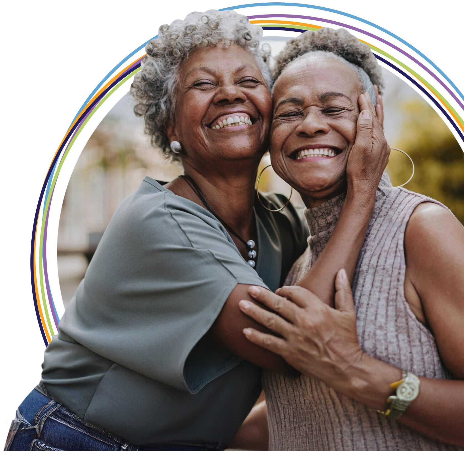 Two older women smiling and hugging