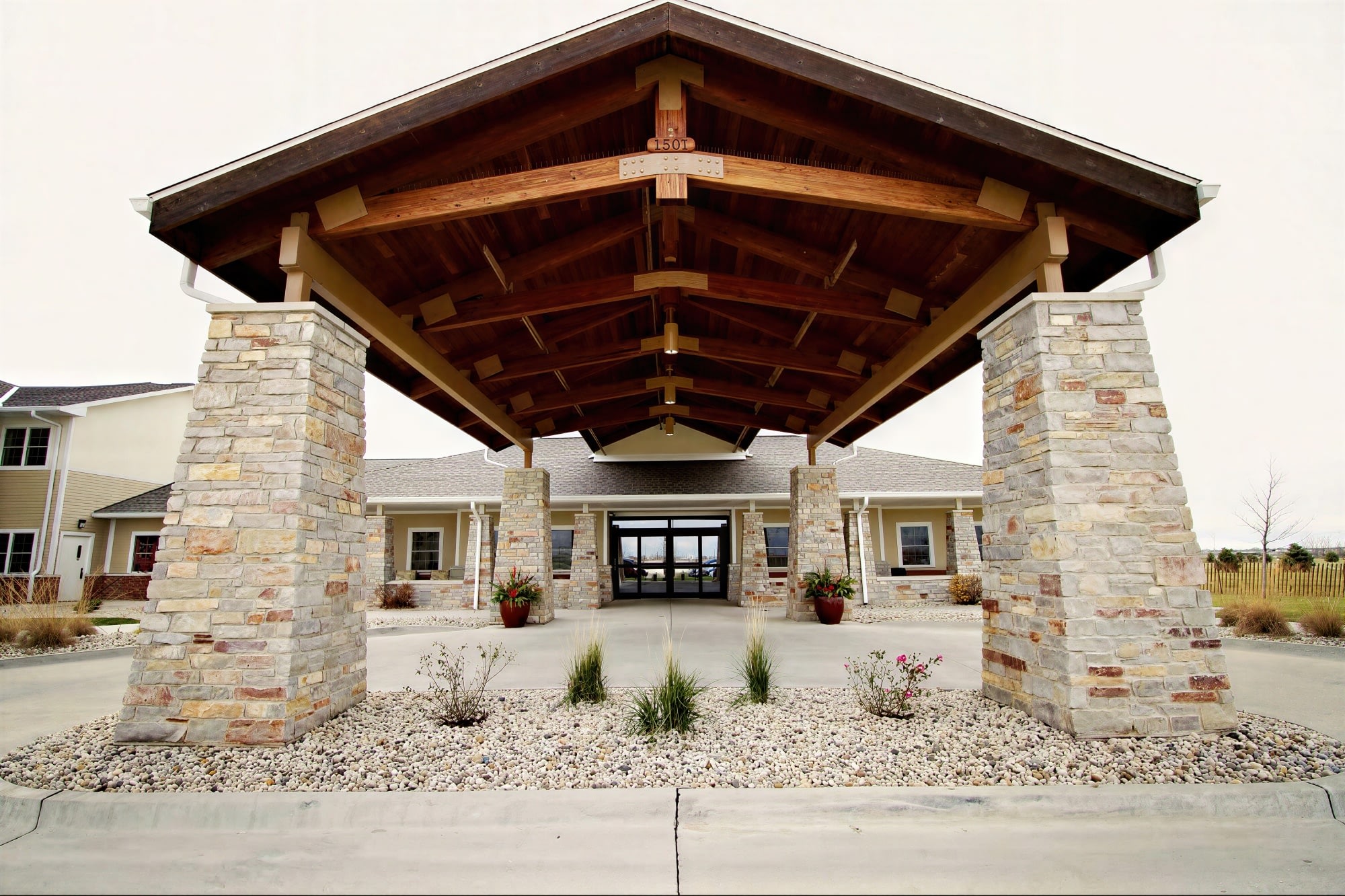 Stone column entrance with large wooden canopy