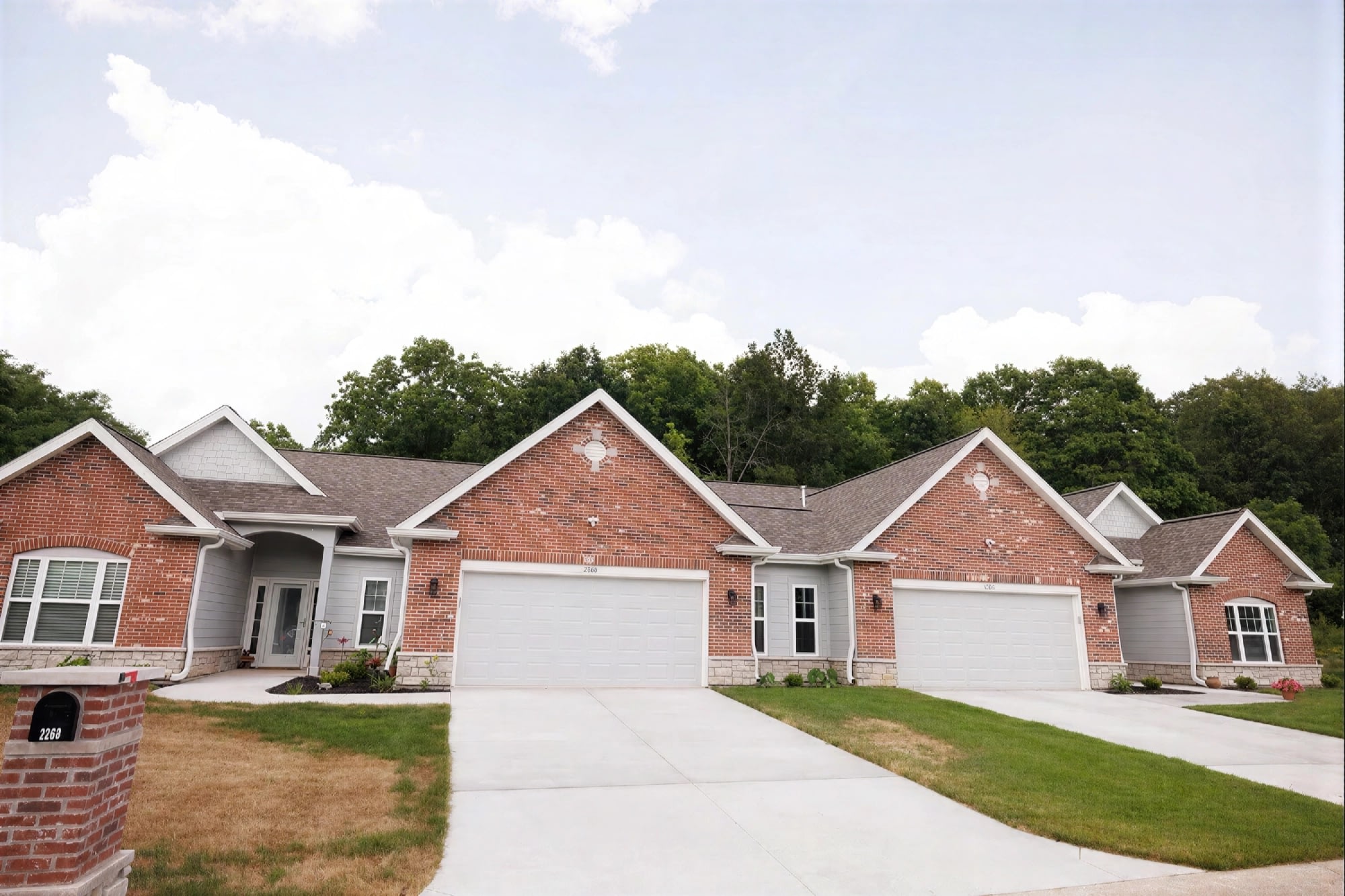 Brick duplex townhomes with garages and driveways