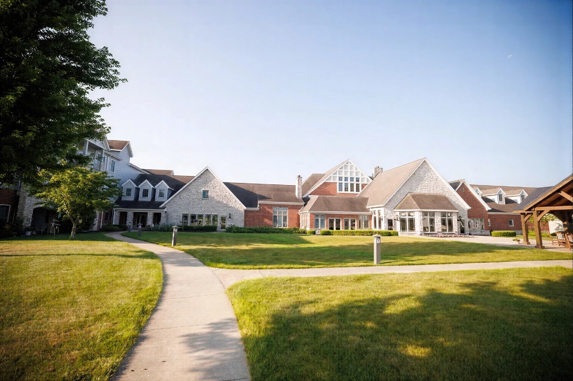 Large brick and stone residential complex with lawn