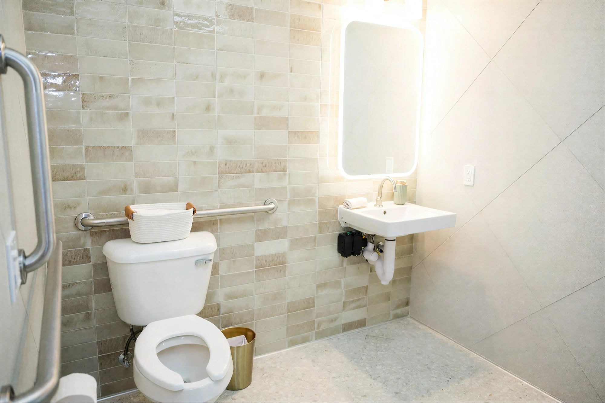 Accessible bathroom with grab bars and wall-mounted sink