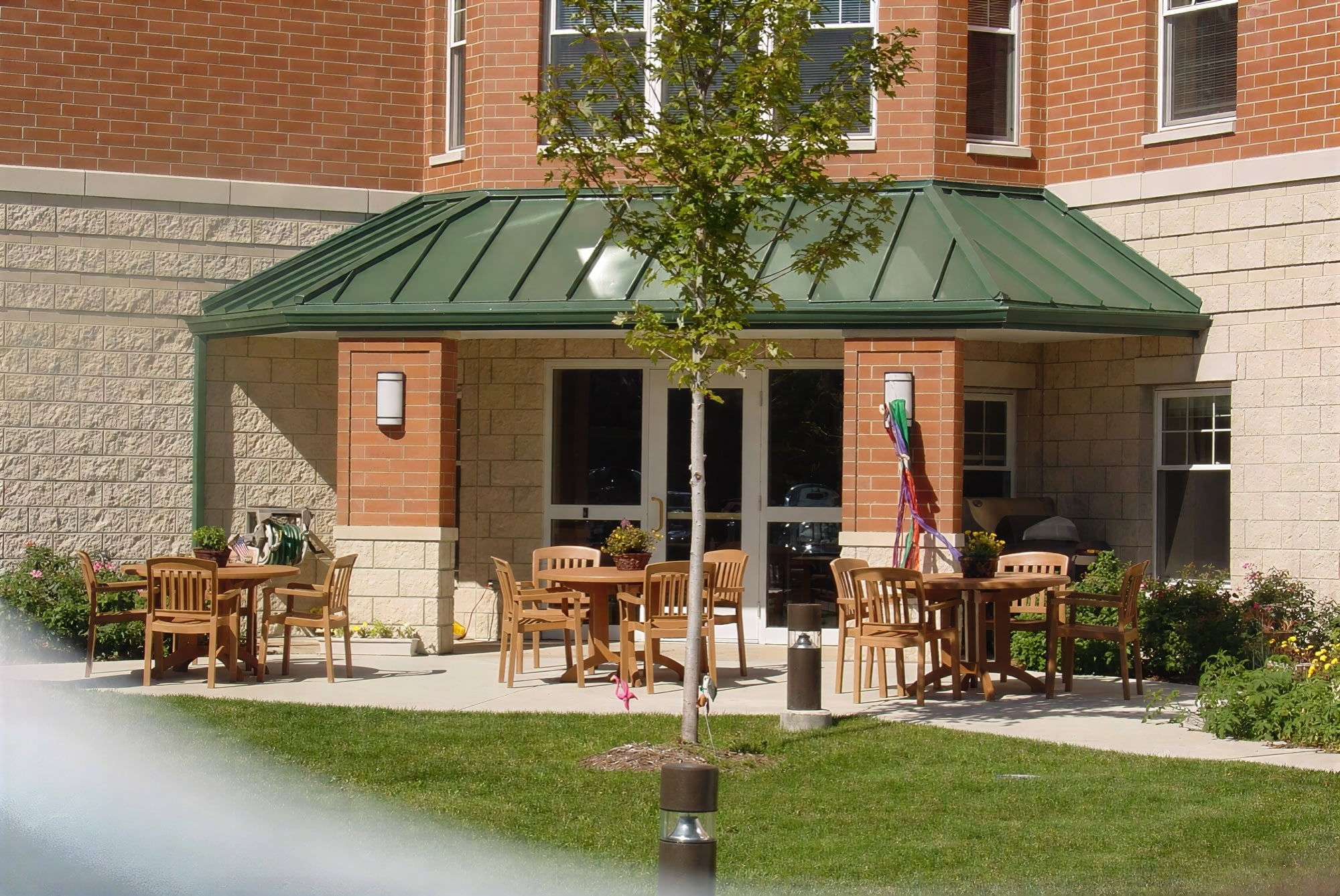 Outdoor patio seating outside brick building entrance