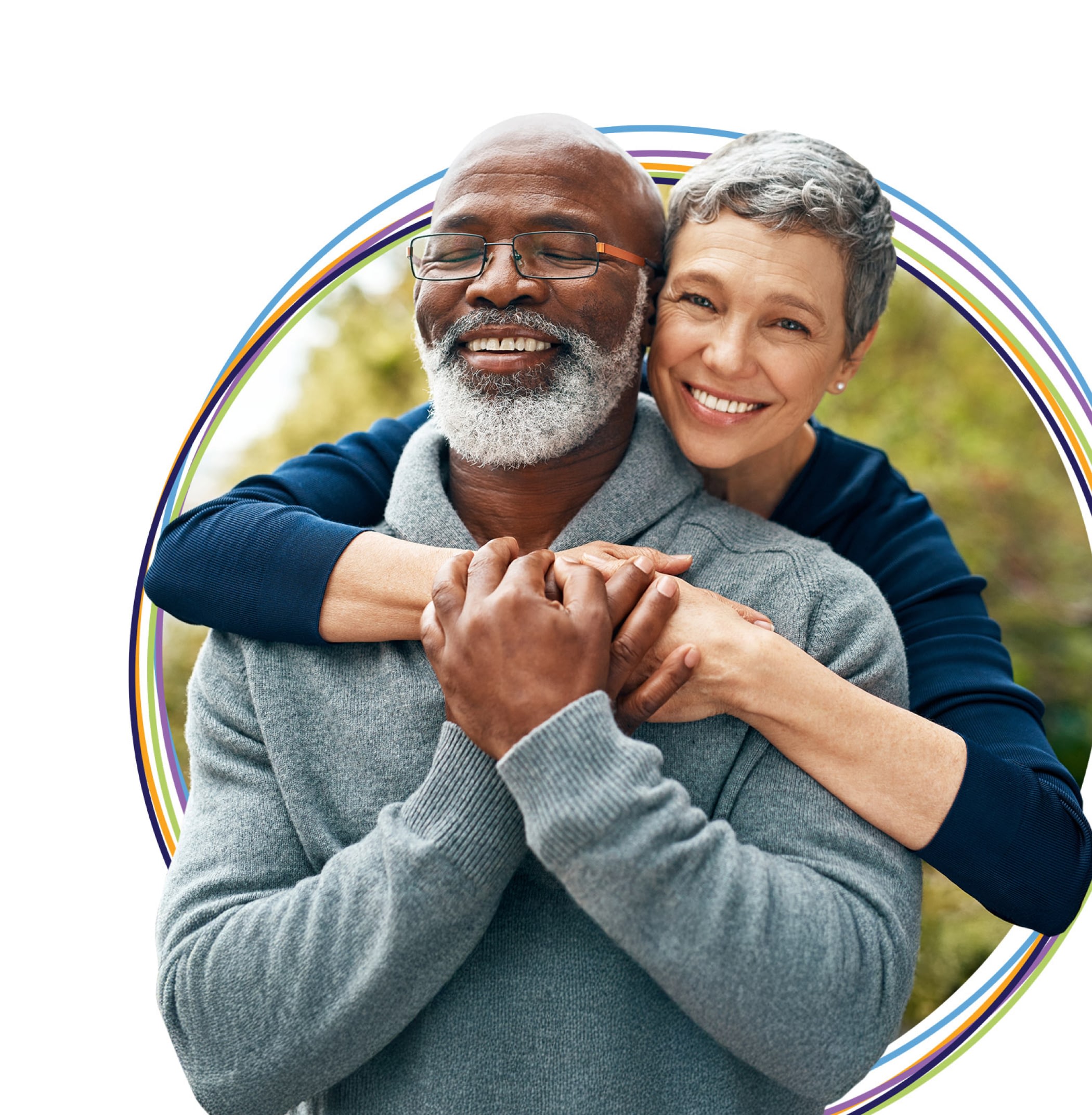 Older couple embracing and smiling outdoors