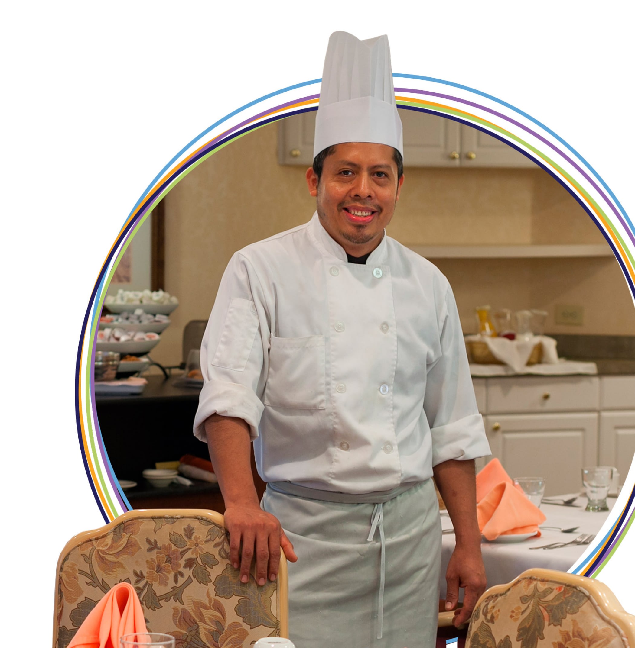 Smiling chef in white uniform and tall hat