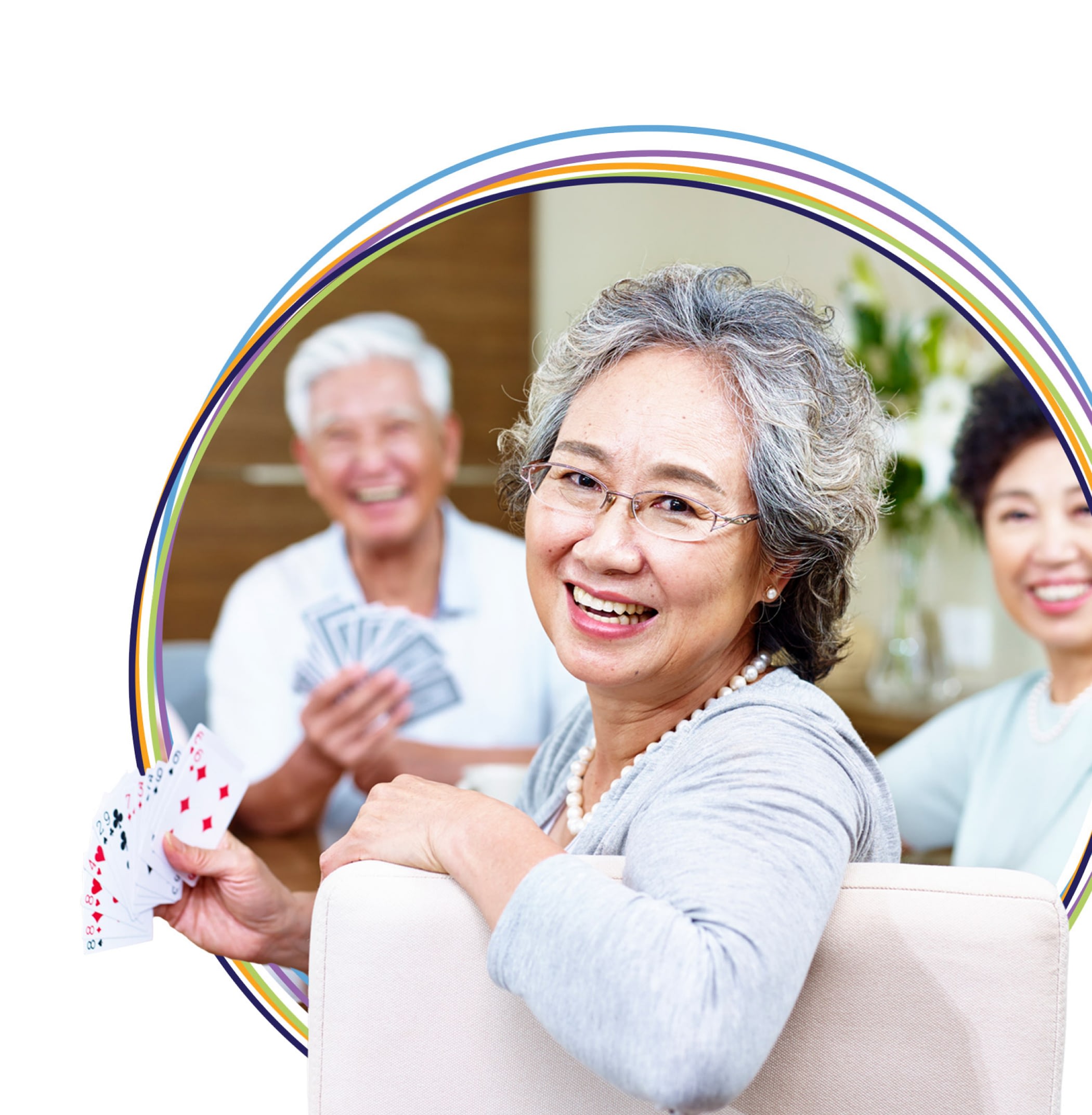 Seniors smiling and playing cards indoors