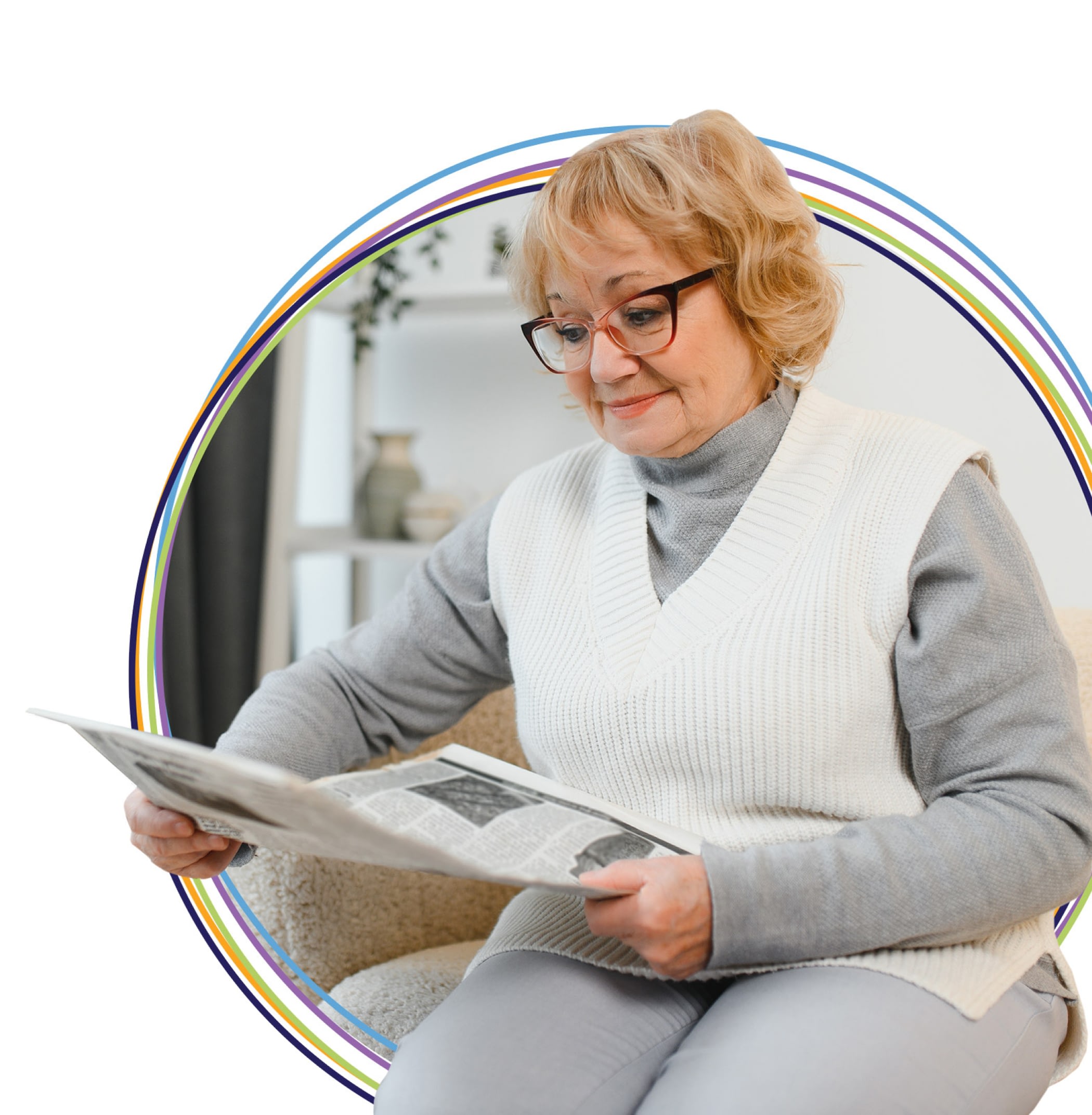 Senior woman reading newspaper at home