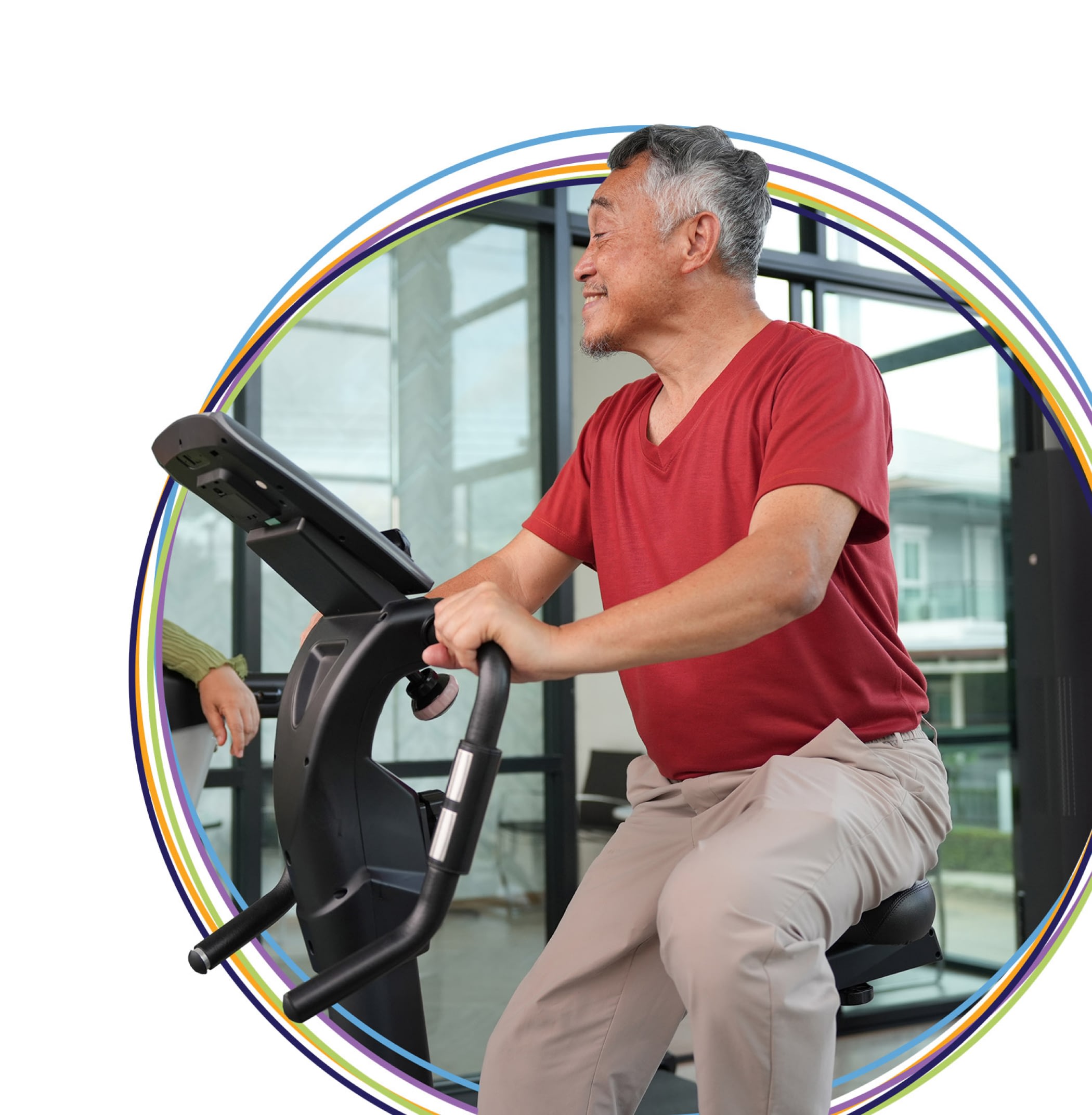 Older man exercising on stationary bike indoors