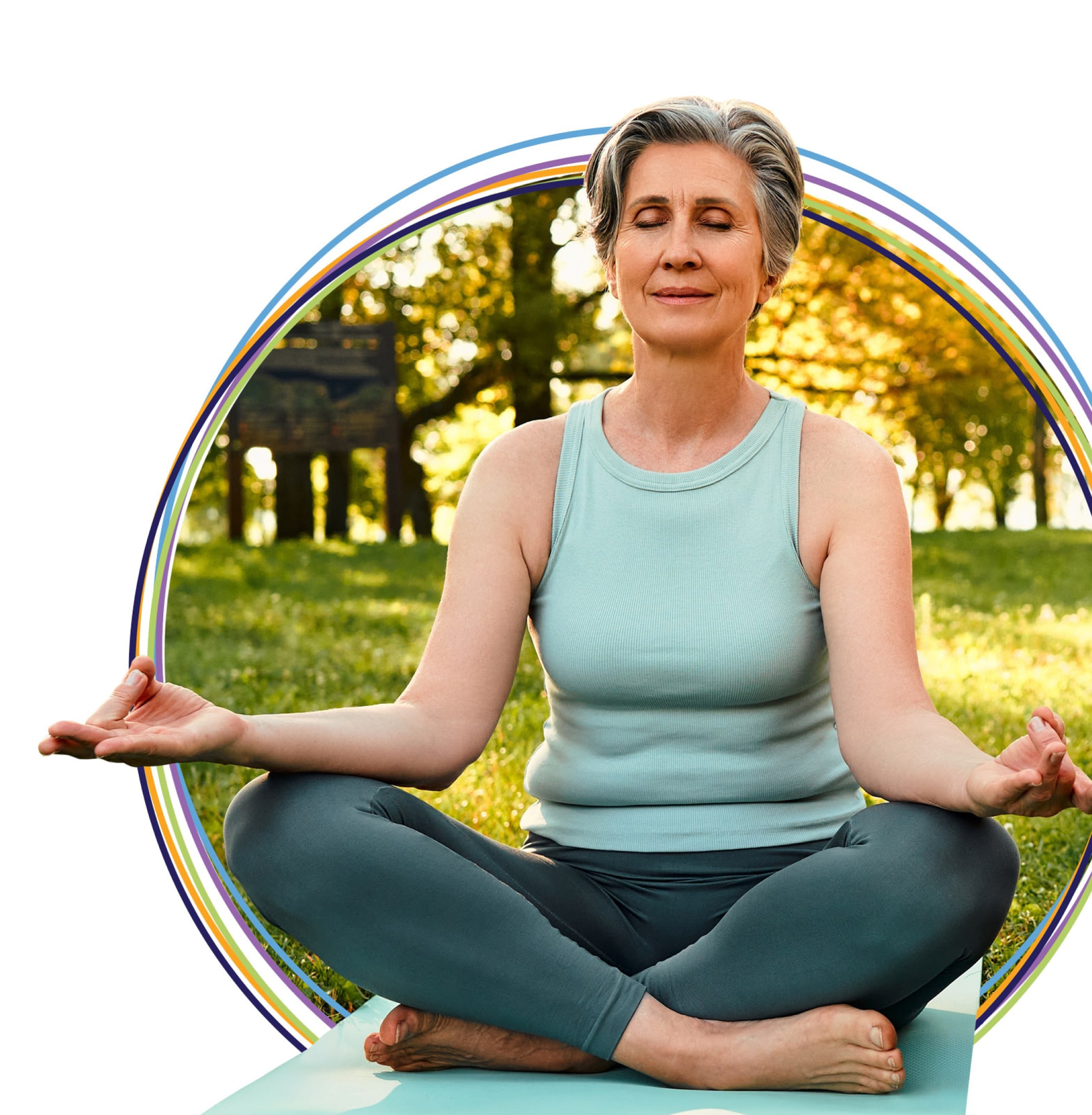 Woman meditating cross-legged in sunny park