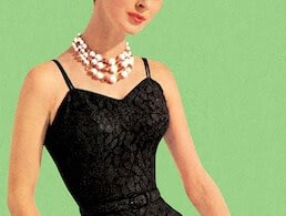 Woman wearing black lace dress and pearl necklace