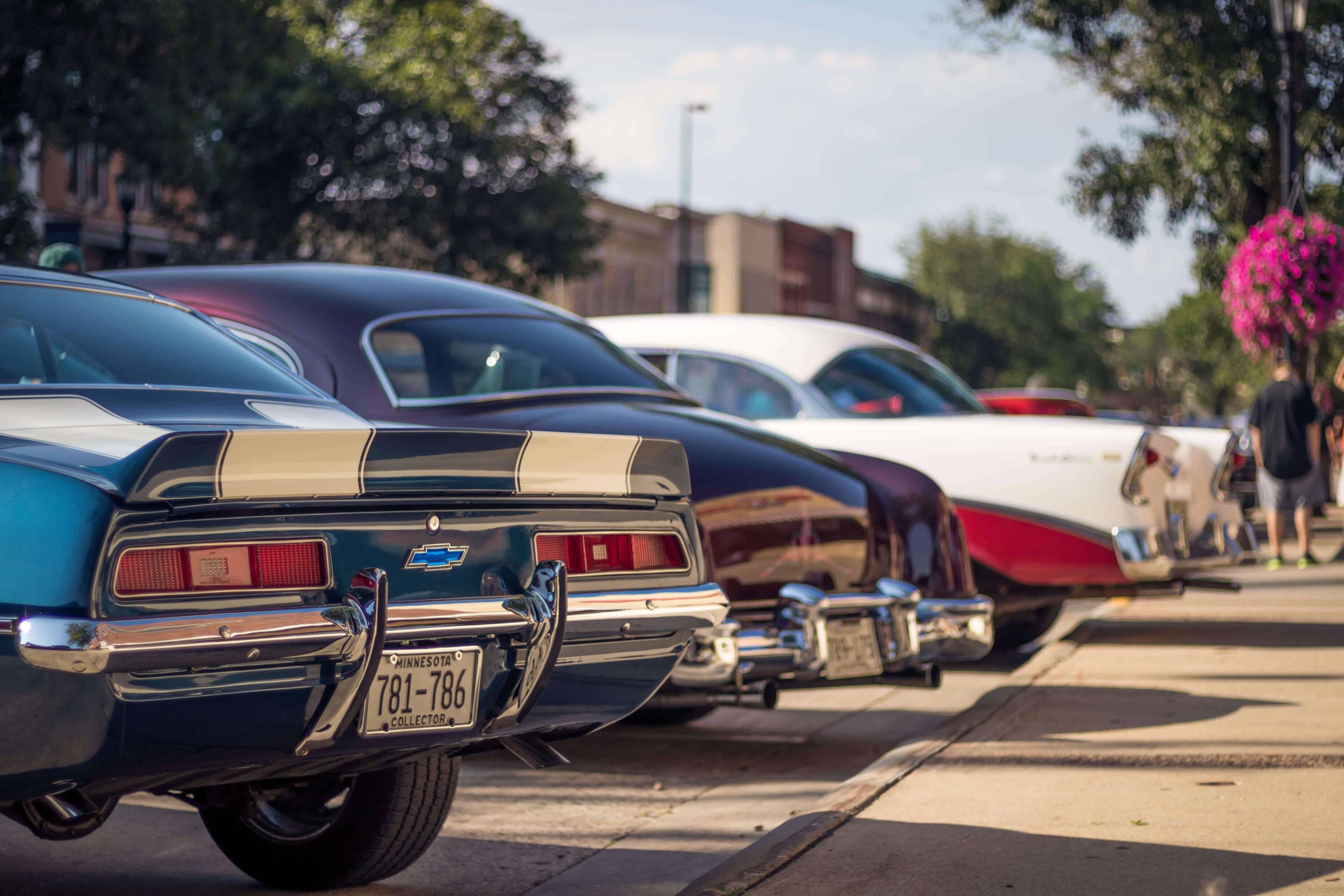 Classic vintage cars parked along sunny street