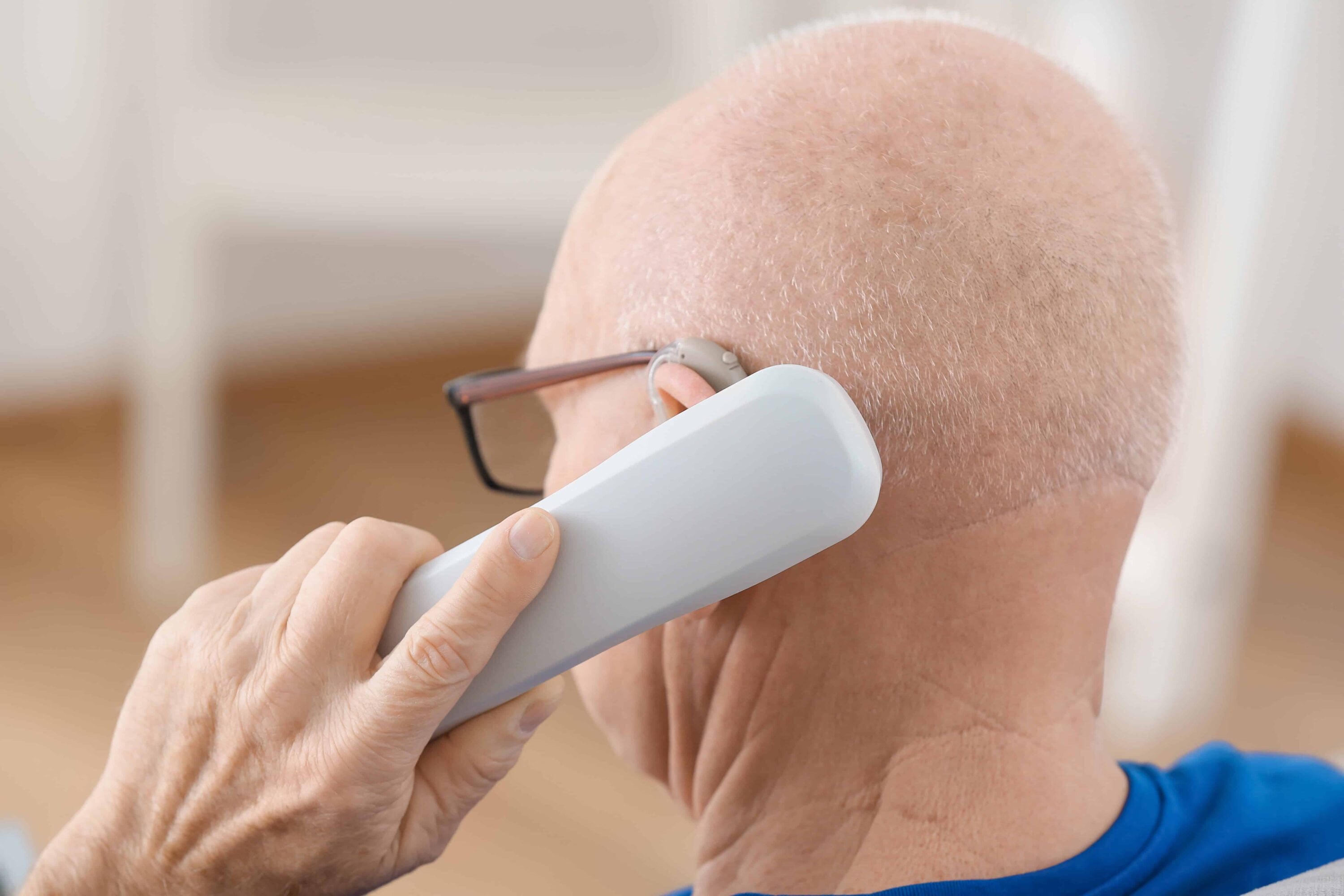 Man holding phone handset to his ear
