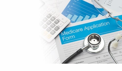 Medicare application form with stethoscope and calculator