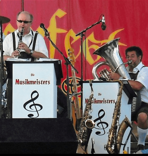 Two musicians playing clarinet and tuba on stage