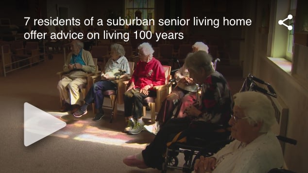Senior residents seated in circle at living home
