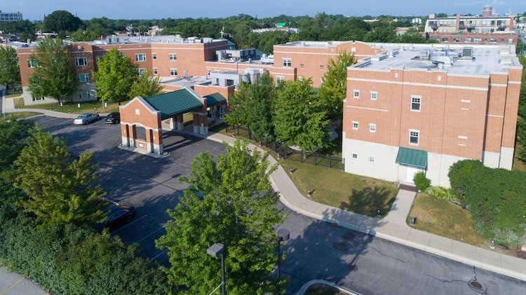 Aerial view of brick school campus buildings