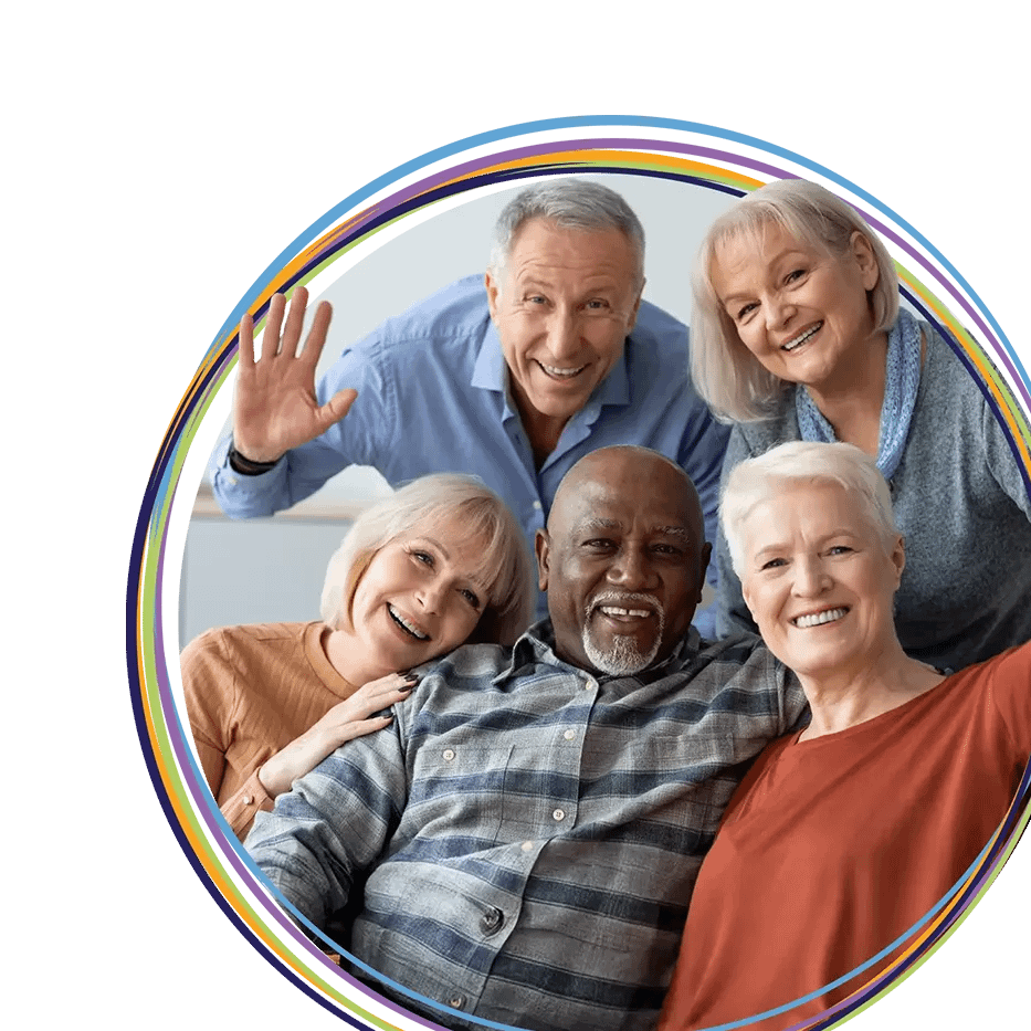 Five smiling seniors posing together in circle frame