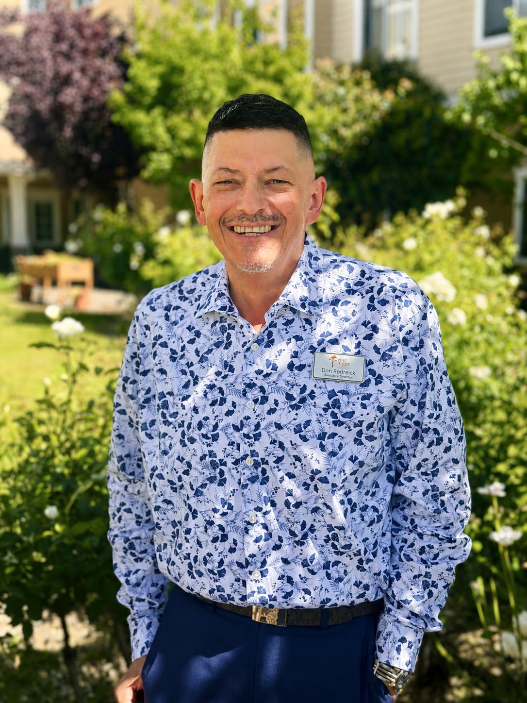 Smiling man wearing floral shirt outdoors