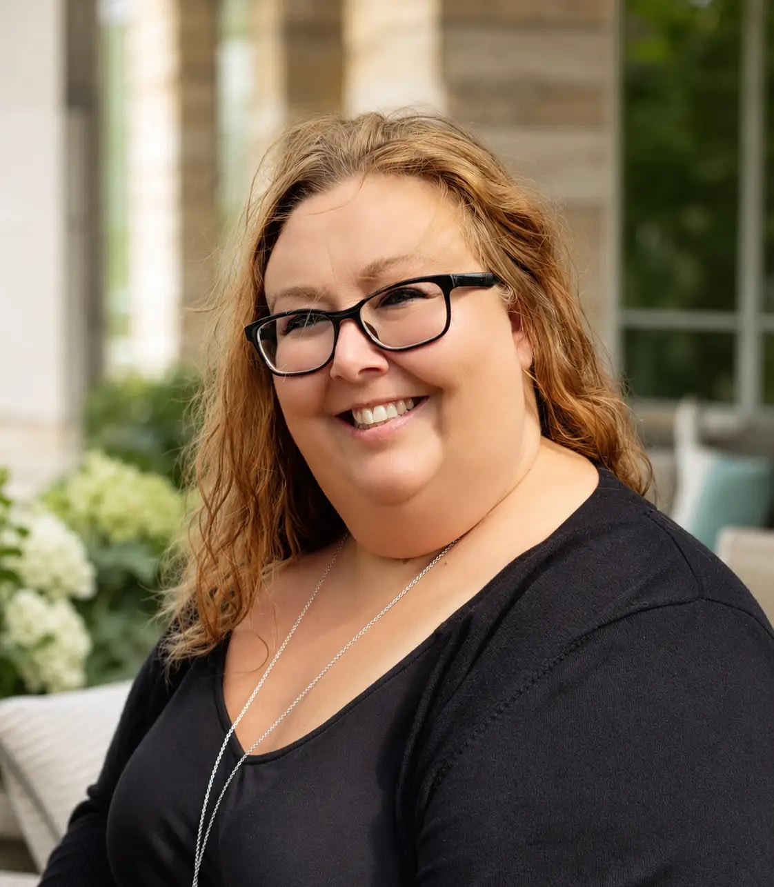 Smiling woman with glasses outdoors portrait