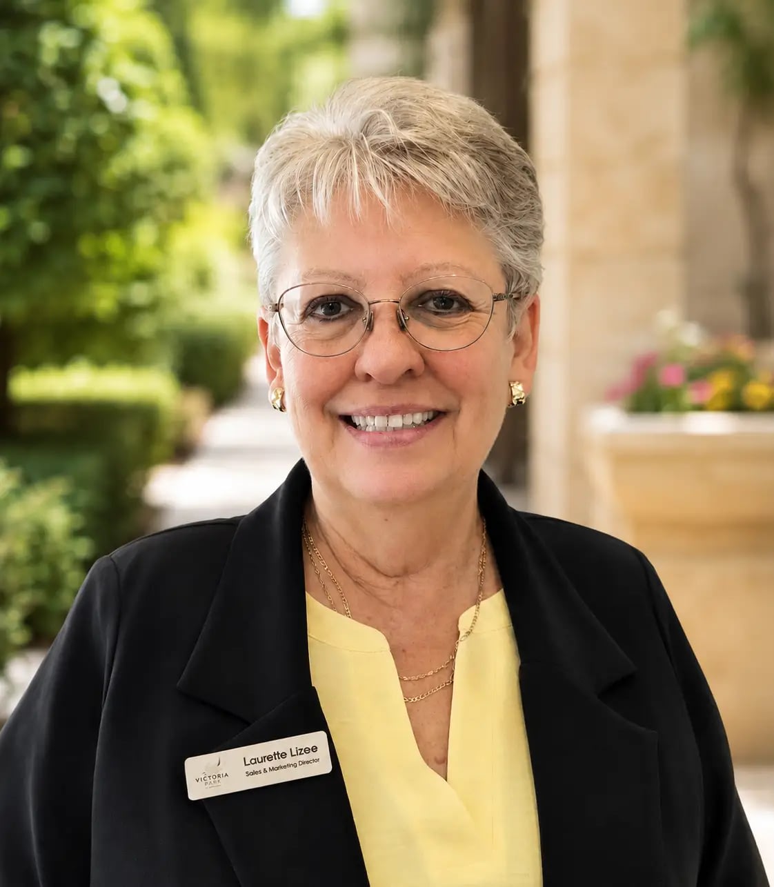 Smiling woman with glasses wearing name badge