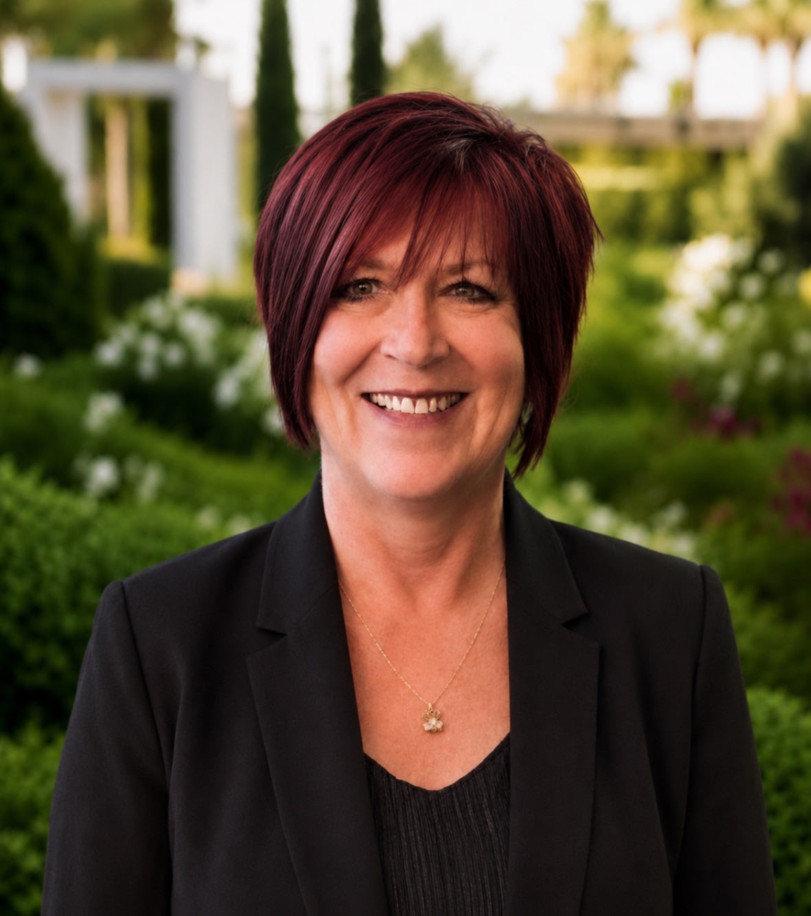 Smiling woman with short red hair outdoors
