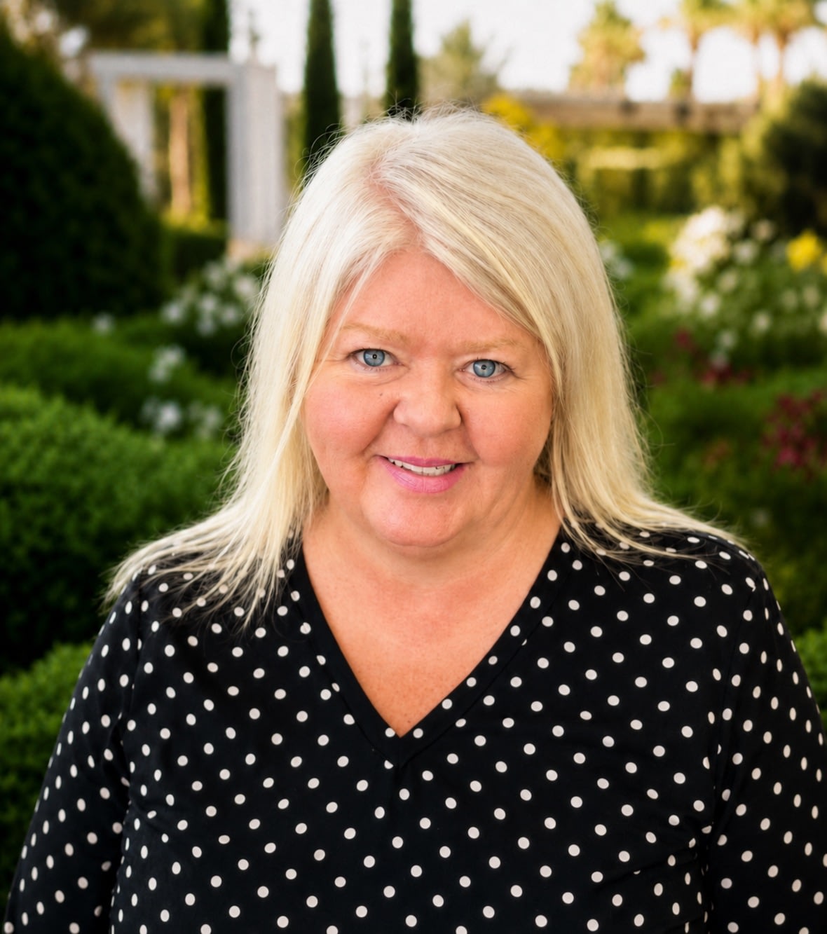Woman in polka dot blouse in garden