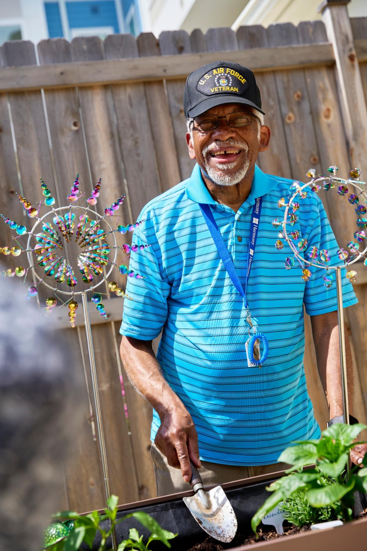 Smiling veteran gardening in backyard planter box
