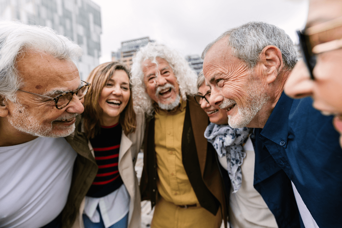 Group of older friends laughing together outdoors