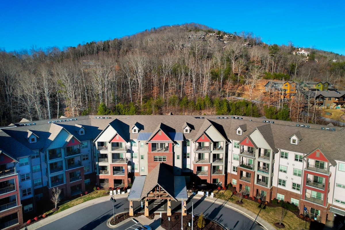 Modern apartment complex with mountain backdrop