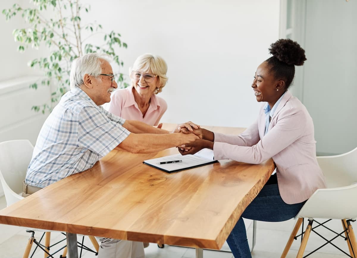 Senior couple meeting with advisor at table