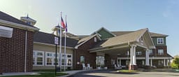 Brick senior living facility with covered entrance