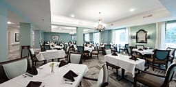 Elegant dining room with white tablecloth tables
