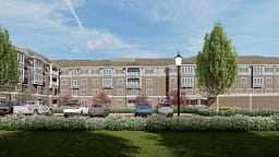 Modern apartment complex with parking and landscaped grounds