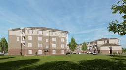 Three-story apartment buildings with lawn and parking
