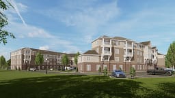 Modern apartment complex with balconies and parking lot
